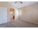 Cozy bedroom featuring neutral walls, soft carpet, and an archway to the bathroom at 18250 N 32Nd St # 1019, Phoenix, AZ 85032