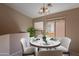 Cozy dining room with stylish chandelier, round table set for four, and a window view at 18250 N 32Nd St # 1019, Phoenix, AZ 85032