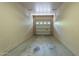 Single-car garage with a concrete floor and a white door at 18250 N 32Nd St # 1019, Phoenix, AZ 85032
