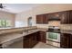 Well-equipped kitchen with stainless steel appliances, sleek countertops, and dark cabinetry at 18250 N 32Nd St # 1019, Phoenix, AZ 85032