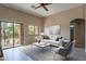 Bright living room with tile flooring, slider to balcony, ceiling fan, and a modern minimalist decor at 18250 N 32Nd St # 1019, Phoenix, AZ 85032
