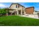 A huge backyard with a covered patio, grassy area, and a refreshing pool; perfect for outdoor entertaining at 18563 W Fairway Dr, Surprise, AZ 85374