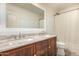 Bathroom with dual sinks, marble countertops and white accents, complemented by a shower at 18563 W Fairway Dr, Surprise, AZ 85374