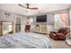Bright bedroom featuring a ceiling fan, carpeted floors and a serene atmosphere at 18563 W Fairway Dr, Surprise, AZ 85374
