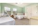 Inviting bedroom with wainscoting, featuring twin beds and ample natural light from two windows at 18563 W Fairway Dr, Surprise, AZ 85374
