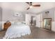 This bedroom has carpeted floors, soft lighting, neutral walls, and a view of the staircase at 18563 W Fairway Dr, Surprise, AZ 85374