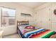Simple bedroom with a bright window and closet, showcasing a cozy and functional space at 18563 W Fairway Dr, Surprise, AZ 85374