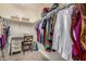 Walk-in closet featuring custom shelving and desk offering ample storage and organization options at 18563 W Fairway Dr, Surprise, AZ 85374