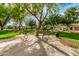 Serene community park featuring mature trees, benches and picnic tables for outdoor enjoyment at 18563 W Fairway Dr, Surprise, AZ 85374
