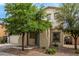 Inviting front exterior showcasing a well-maintained yard and a charming facade with mature trees at 18563 W Fairway Dr, Surprise, AZ 85374