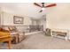 Relaxing living room featuring a comfy recliner, a ceiling fan and a view of the upper level at 18563 W Fairway Dr, Surprise, AZ 85374