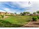 Well-kept green park with manicured shrubbery and shady trees, offering a serene outdoor space for residents at 18563 W Fairway Dr, Surprise, AZ 85374