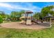 Fun playground area with slides, climbing structures, and a covered picnic spot for families at 18563 W Fairway Dr, Surprise, AZ 85374
