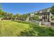 Beautifully landscaped backyard featuring a green lawn, mature trees, and a covered patio at 1890 E Sagittarius Pl, Chandler, AZ 85249