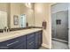 Well lit bathroom features a quartz countertop and double sinks with a glass enclosed shower at 1890 E Sagittarius Pl, Chandler, AZ 85249