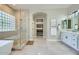 Luxurious bathroom boasts a soaking tub, a glass shower, and modern white cabinets at 1890 E Sagittarius Pl, Chandler, AZ 85249