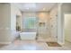 Bright bathroom features a soaking tub, glass enclosed shower and decorative glass block window at 1890 E Sagittarius Pl, Chandler, AZ 85249
