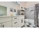 Bright bathroom features a vanity with white cabinets, quartz countertop and a shower/tub combo at 1890 E Sagittarius Pl, Chandler, AZ 85249