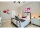 Bedroom featuring a black wrought iron queen sized bed, a desk and a dresser at 1890 E Sagittarius Pl, Chandler, AZ 85249