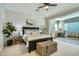 Comfortable bedroom with a large bed, neutral decor, and a connected office space at 1890 E Sagittarius Pl, Chandler, AZ 85249