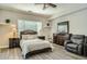 Comfortable bedroom features a cozy bed, wood floors, and ample space for relaxation at 1890 E Sagittarius Pl, Chandler, AZ 85249