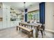 Open-concept dining area with modern table, bench seating, and bright, natural light filtering through the windows at 1890 E Sagittarius Pl, Chandler, AZ 85249