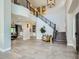 Grand entryway with high ceilings, tile flooring, staircase, and views into the living spaces at 1890 E Sagittarius Pl, Chandler, AZ 85249