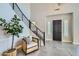 Grand foyer featuring a metal staircase, sleek tiling, and a modern chair at 1890 E Sagittarius Pl, Chandler, AZ 85249