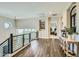 Bright hallway features wood floors, modern railing, and an open doorway to a bedroom at 1890 E Sagittarius Pl, Chandler, AZ 85249