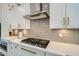 Close up of a contemporary kitchen with white cabinets, quartz countertop, and stainless steel appliances at 1890 E Sagittarius Pl, Chandler, AZ 85249