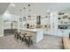 Bright and spacious kitchen featuring a large center island, modern lighting, and stainless steel appliances at 1890 E Sagittarius Pl, Chandler, AZ 85249