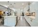 Spacious kitchen features white cabinets, stainless steel appliances, a large island, and modern fixtures at 1890 E Sagittarius Pl, Chandler, AZ 85249