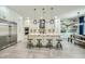 Open kitchen design with stainless appliances, white cabinets, and a large center island with stool seating at 1890 E Sagittarius Pl, Chandler, AZ 85249