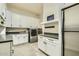 Well-organized laundry room with ample white cabinetry, modern appliances, and gray countertops at 1890 E Sagittarius Pl, Chandler, AZ 85249