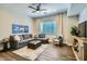 Inviting living room featuring a comfortable sectional sofa, ceiling fan, and contemporary decor at 1890 E Sagittarius Pl, Chandler, AZ 85249