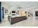 Spacious living room featuring a large sofa, fireplace, built-in shelving, and open access to the staircase at 1890 E Sagittarius Pl, Chandler, AZ 85249