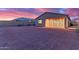 Expansive backyard features desert landscaping and a covered patio, perfect for outdoor entertaining at 19873 W San Juan Ave, Litchfield Park, AZ 85340