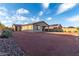 Full view of the home's backyard featuring desert landscaping, hardscape, and room to customize at 19873 W San Juan Ave, Litchfield Park, AZ 85340