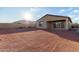Large backyard, showcasing low-maintenance landscaping and a covered patio, perfect for outdoor relaxation at 19873 W San Juan Ave, Litchfield Park, AZ 85340