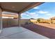 Covered backyard patio overlooks a spacious yard, perfect for outdoor relaxation and gatherings at 19873 W San Juan Ave, Litchfield Park, AZ 85340