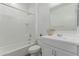 Bright bathroom featuring a shower-tub combo, vanity with white cabinets and modern fixtures at 19873 W San Juan Ave, Litchfield Park, AZ 85340