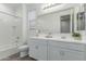 Bright bathroom featuring a tiled shower/tub and a dual sink vanity at 19873 W San Juan Ave, Litchfield Park, AZ 85340