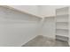 Walk-in closet featuring wood clothing rods and shelving at 19873 W San Juan Ave, Litchfield Park, AZ 85340