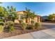 Well-maintained front yard with mature trees, desert landscaping, and a charming single-story house at 19873 W San Juan Ave, Litchfield Park, AZ 85340