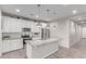 Stylish kitchen featuring granite countertops, stainless steel appliances, and a functional center island with pendant lights at 19873 W San Juan Ave, Litchfield Park, AZ 85340