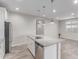 Bright kitchen boasts white cabinetry, stainless steel appliances, and a functional center island at 19873 W San Juan Ave, Litchfield Park, AZ 85340