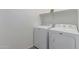 Laundry room with modern, white, Maytag washer and dryer appliances at 19873 W San Juan Ave, Litchfield Park, AZ 85340