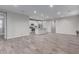 Open-concept living room featuring tile flooring, recessed lighting, and seamless transition to the kitchen area at 19873 W San Juan Ave, Litchfield Park, AZ 85340