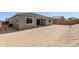 Backyard showcasing the home's patio, windows, and block wall for privacy at 20274 W Monterey Way, Buckeye, AZ 85396
