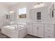 Bright bathroom with soaking tub and dual sink vanity at 20274 W Monterey Way, Buckeye, AZ 85396